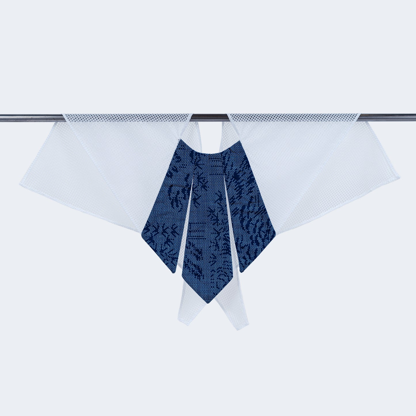 A dotted blue and white scarf with a unique collar design, displayed on a hanger.