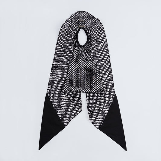 Silk scrunchie opened fully, showing flexible elastic and detailed dotted pattern.