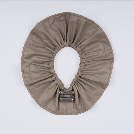 A khaki nylon adjustable hair band shown fully open from above, highlighting the smooth nylon material and innovative fastener.