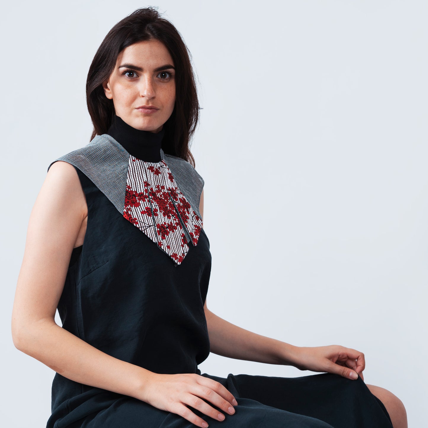 Model wearing elegant collar accessory with floral print and sheer gray mesh