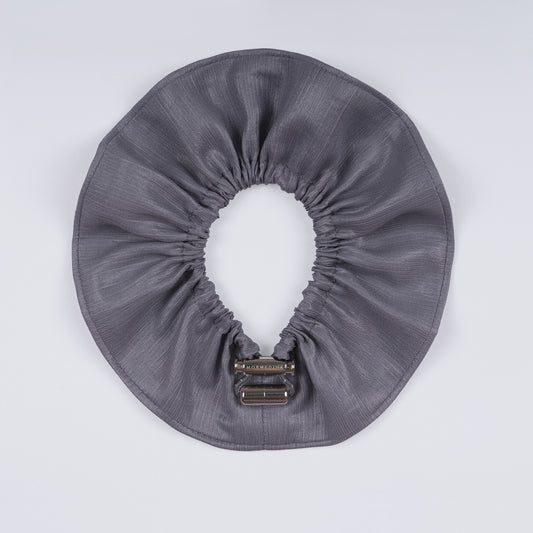 Silver scrunchie opened fully, highlighting flexible elastic.