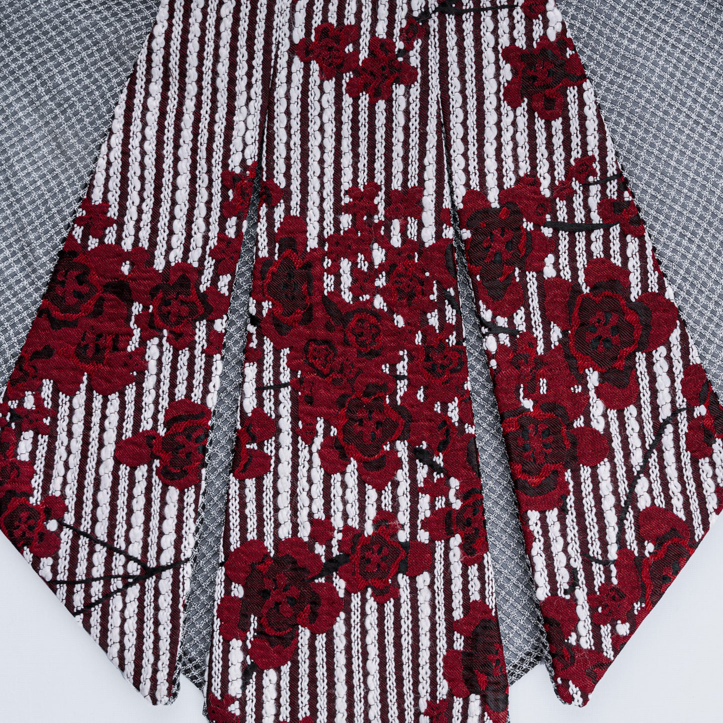 Detailed close-up of floral print collar with sheer gray mesh fabric