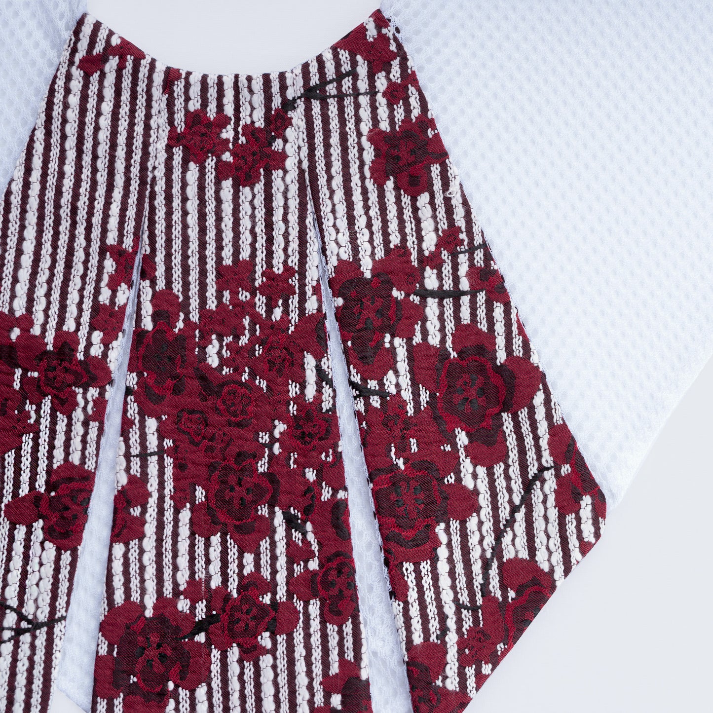 Close-up of floral print collar with sheer white mesh fabric