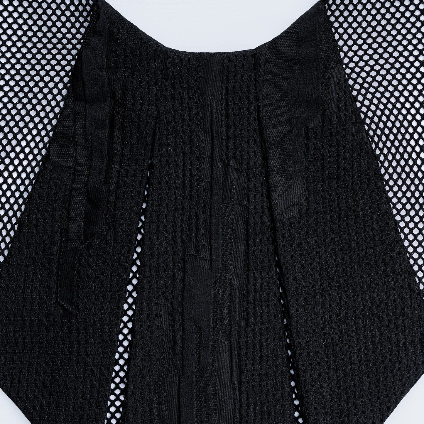 Close-up of Japanese geometric black silk collar with sheer black mesh
