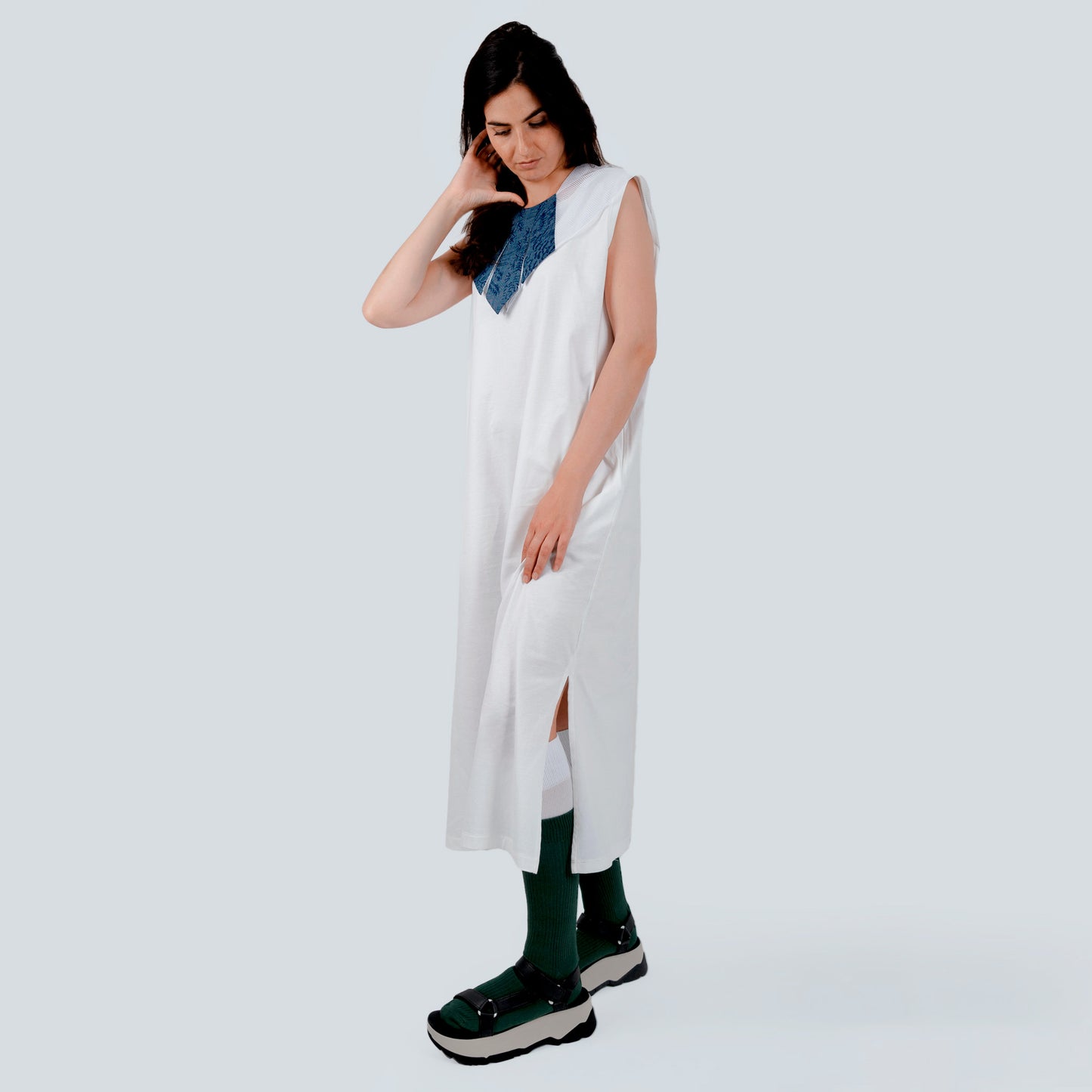Model wearing silk collar over white dress