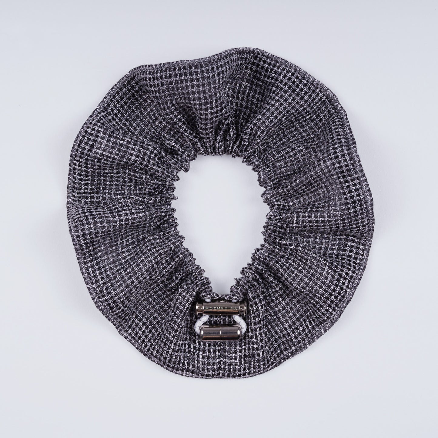 Gray squares scrunchie opened fully to show the flexible elastic and structured design.