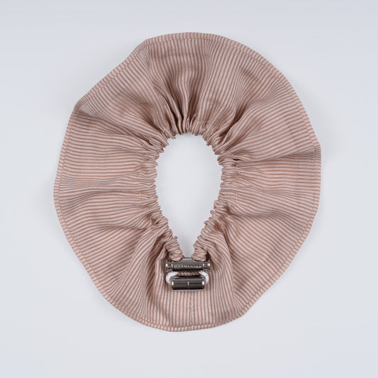Striped scrunchie opened fully to reveal flexible elastic and elegant cotton texture.