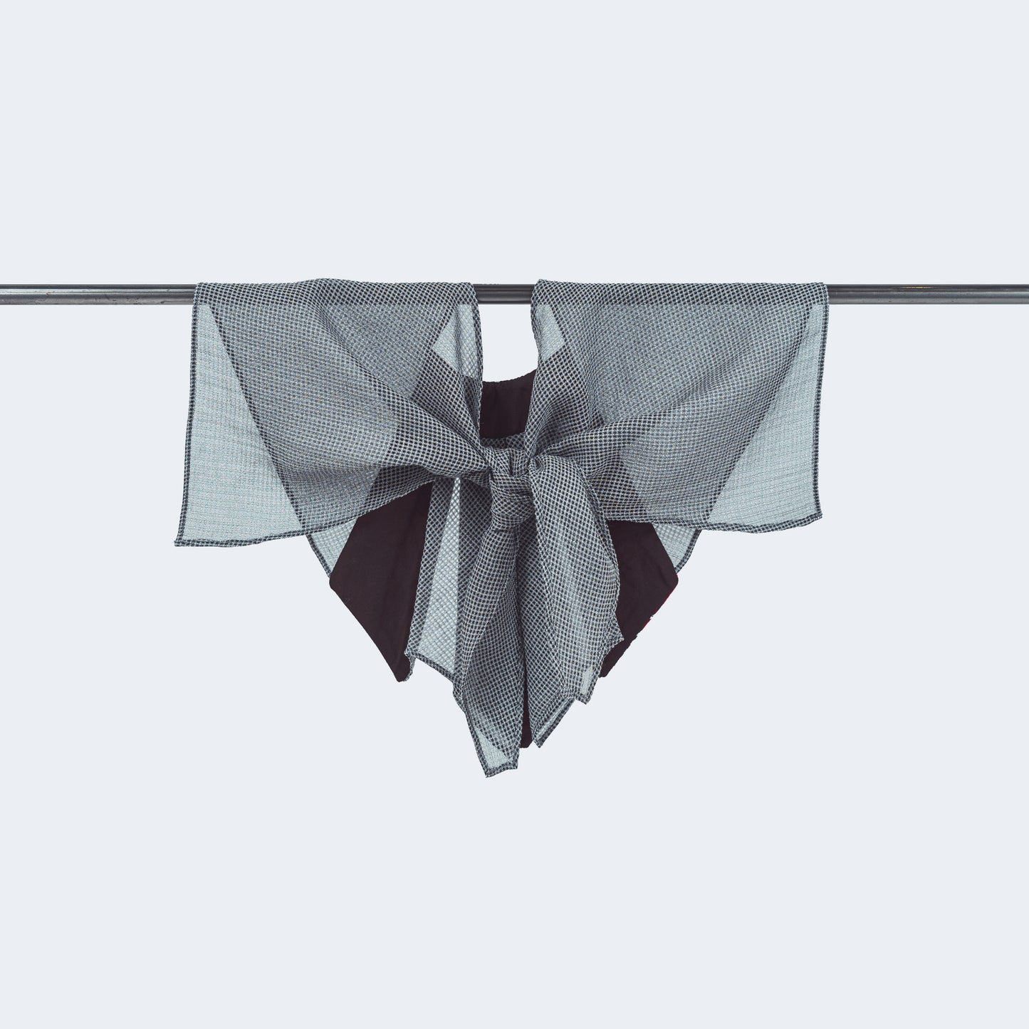 Back view of floral print and sheer gray mesh collar tied, displayed on hanger