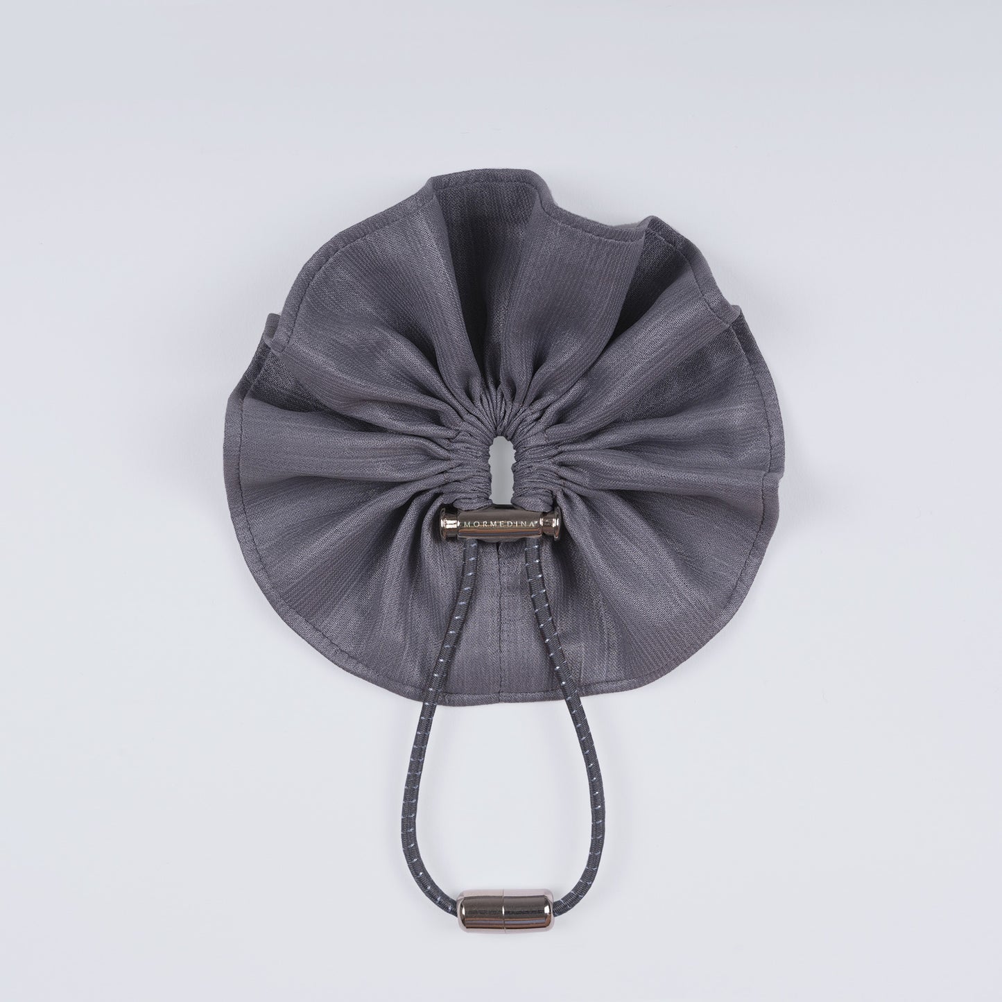 Shiny silver scrunchie displayed closed on a white background, showing its unique fastener and smooth texture.