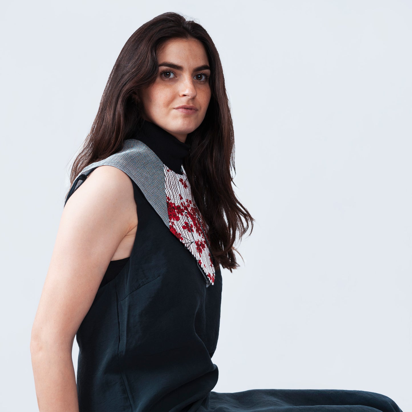 Model showcasing refined collar accessory with floral print and sheer gray mesh