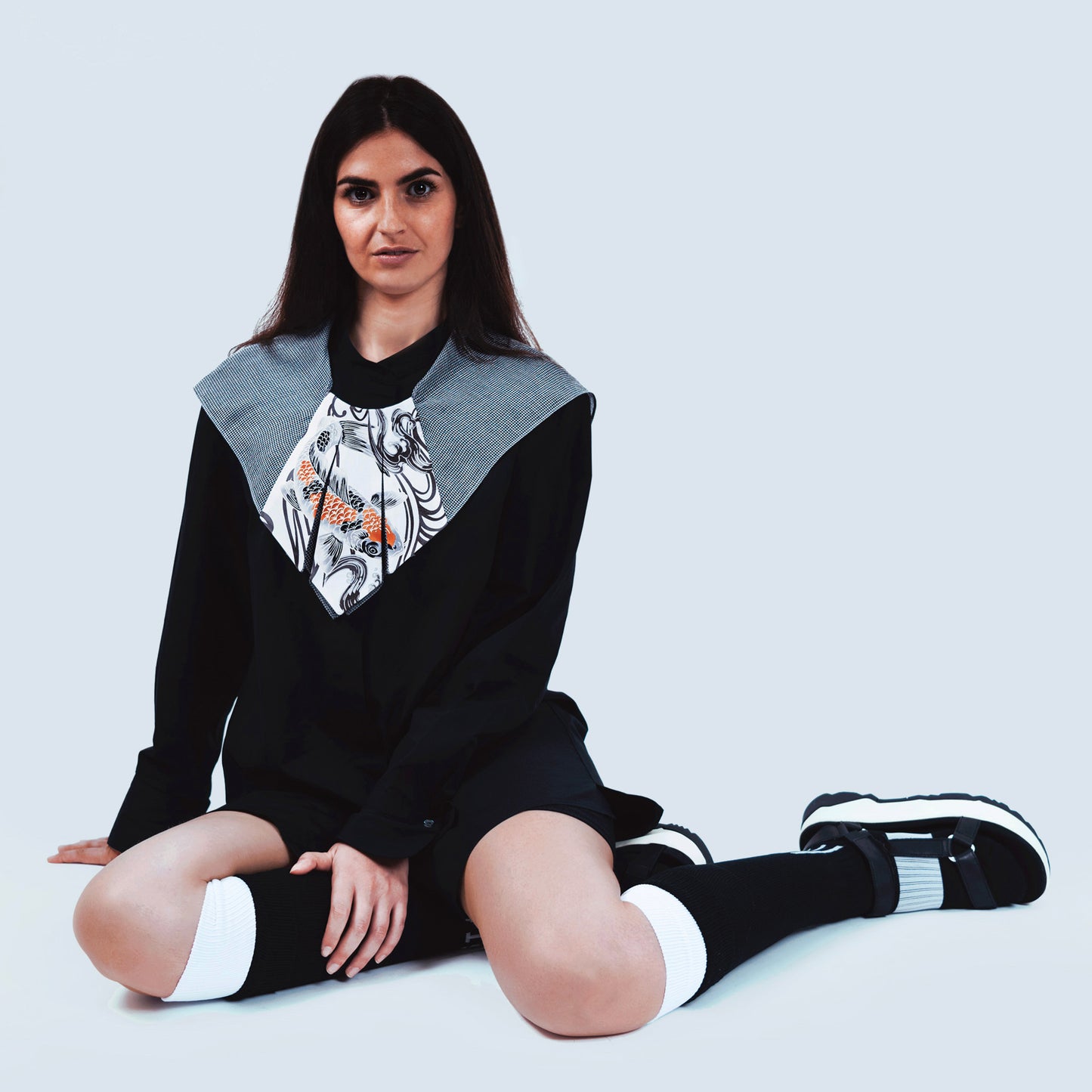 Model showcasing limited edition Japanese fish print and sheer gray fabric collar