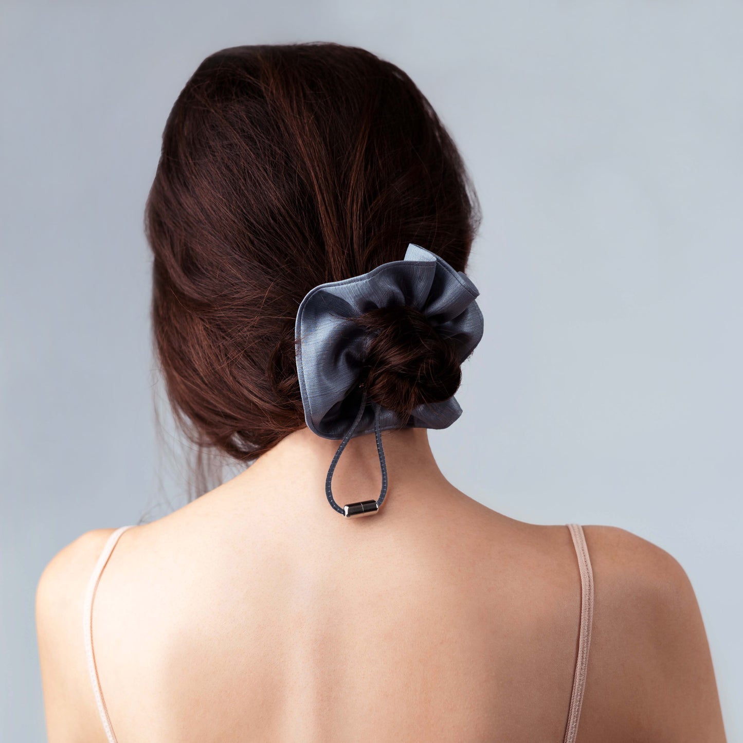 Model wearing the shiny silver scrunchie, showing adjustability, comfort, and refined everyday style.