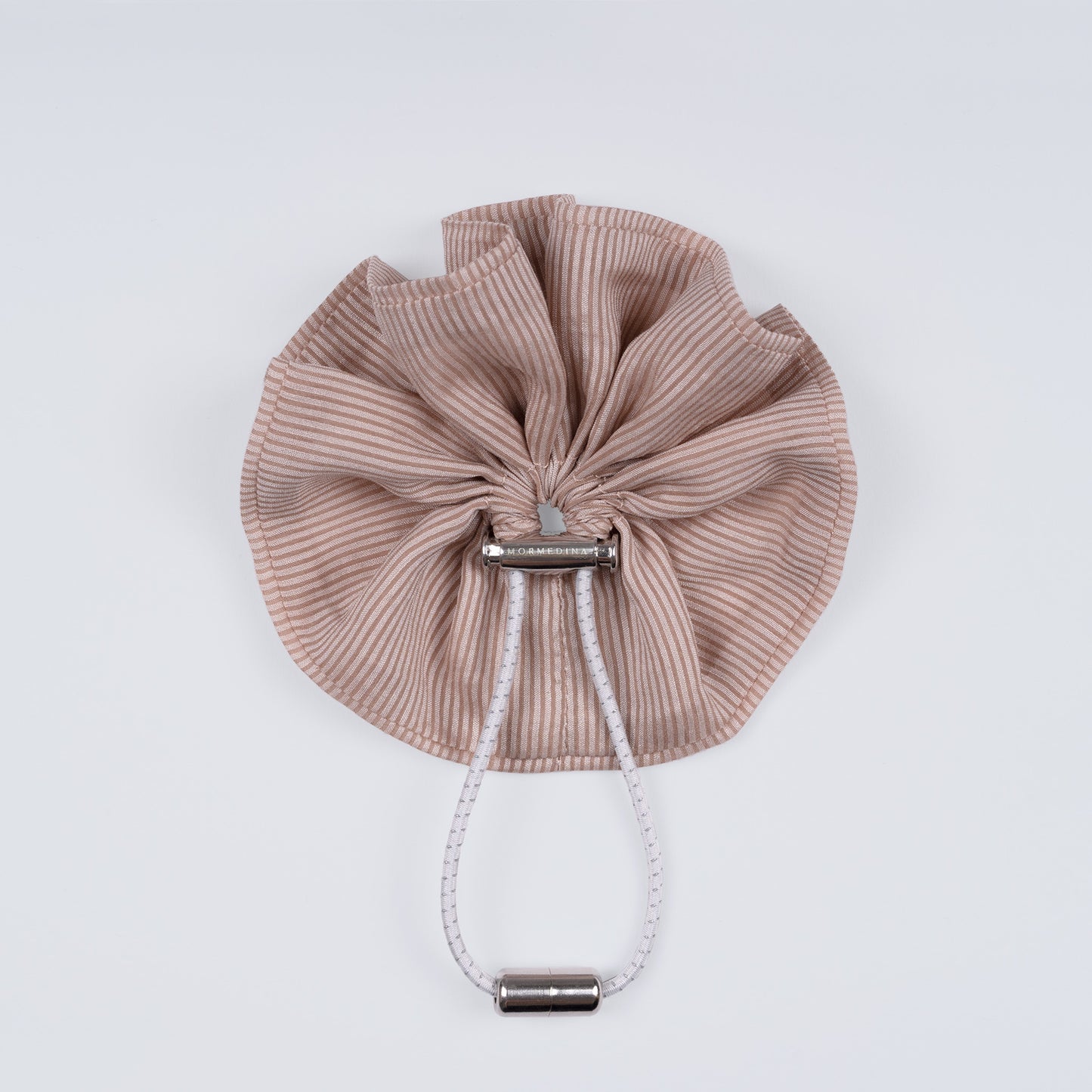Nude brown and pink striped scrunchie displayed closed on a white background, showing the unique fastener.