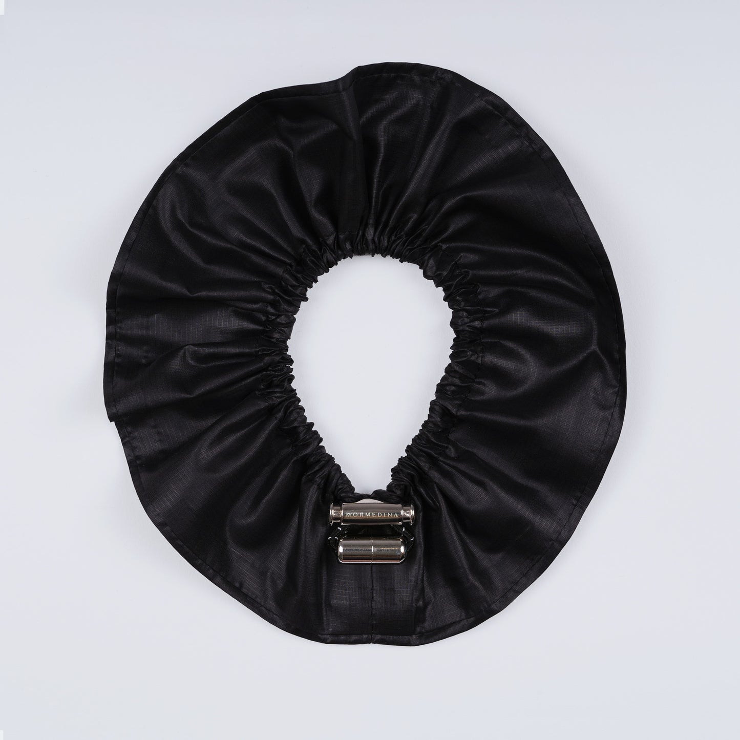 Black ripstop nylon adjustable scrunchie shown fully open from above.
