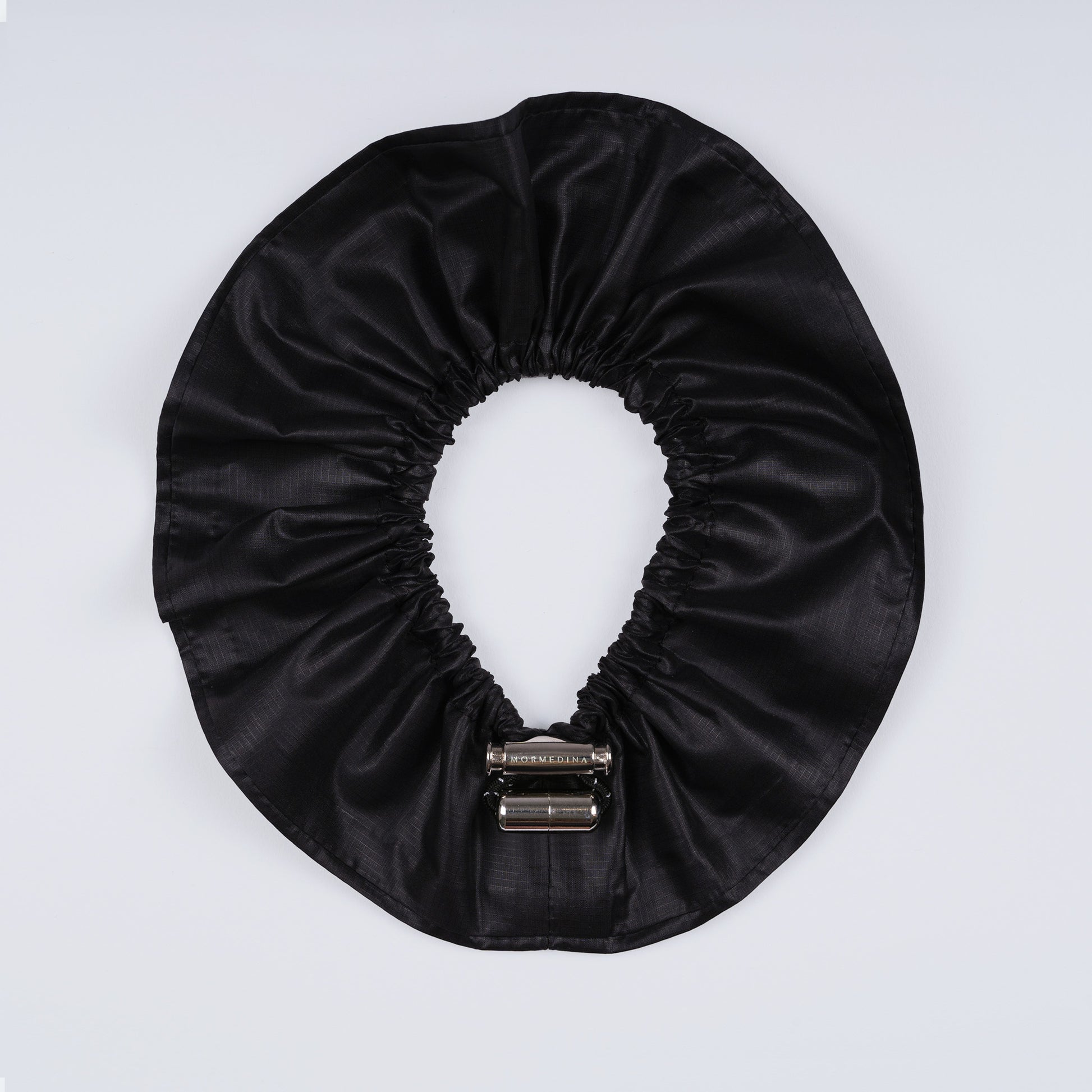 Black ripstop nylon adjustable scrunchie shown fully open from above.
