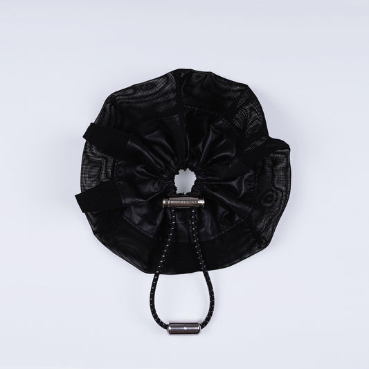 A black ripstop nylon and mesh adjustable scrunchie, displayed closed on a white background to show its sleek fastener design.
