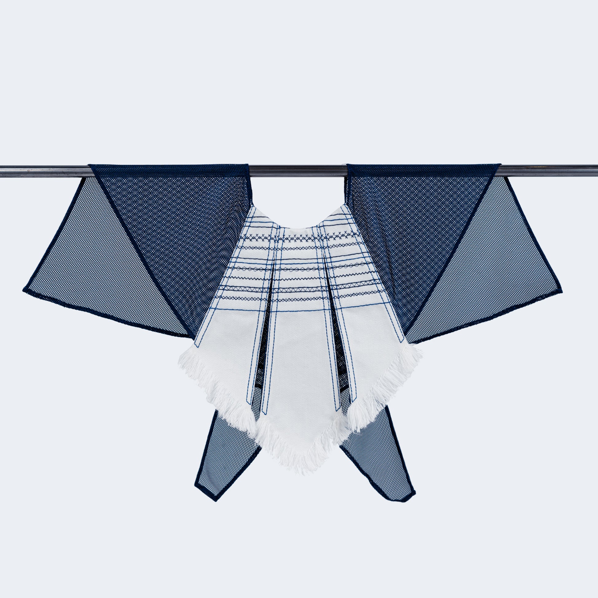 Front view of embroidered white denim and blue mesh collar on hanger
