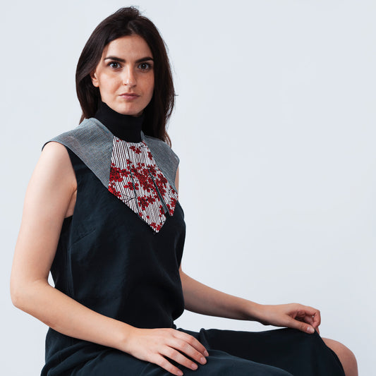 Model wearing elegant collar accessory with floral print and sheer gray mesh
