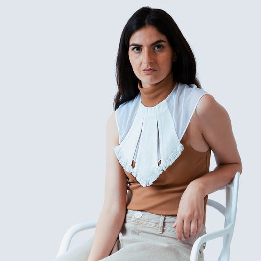 Model styling white collar with neutral outfit