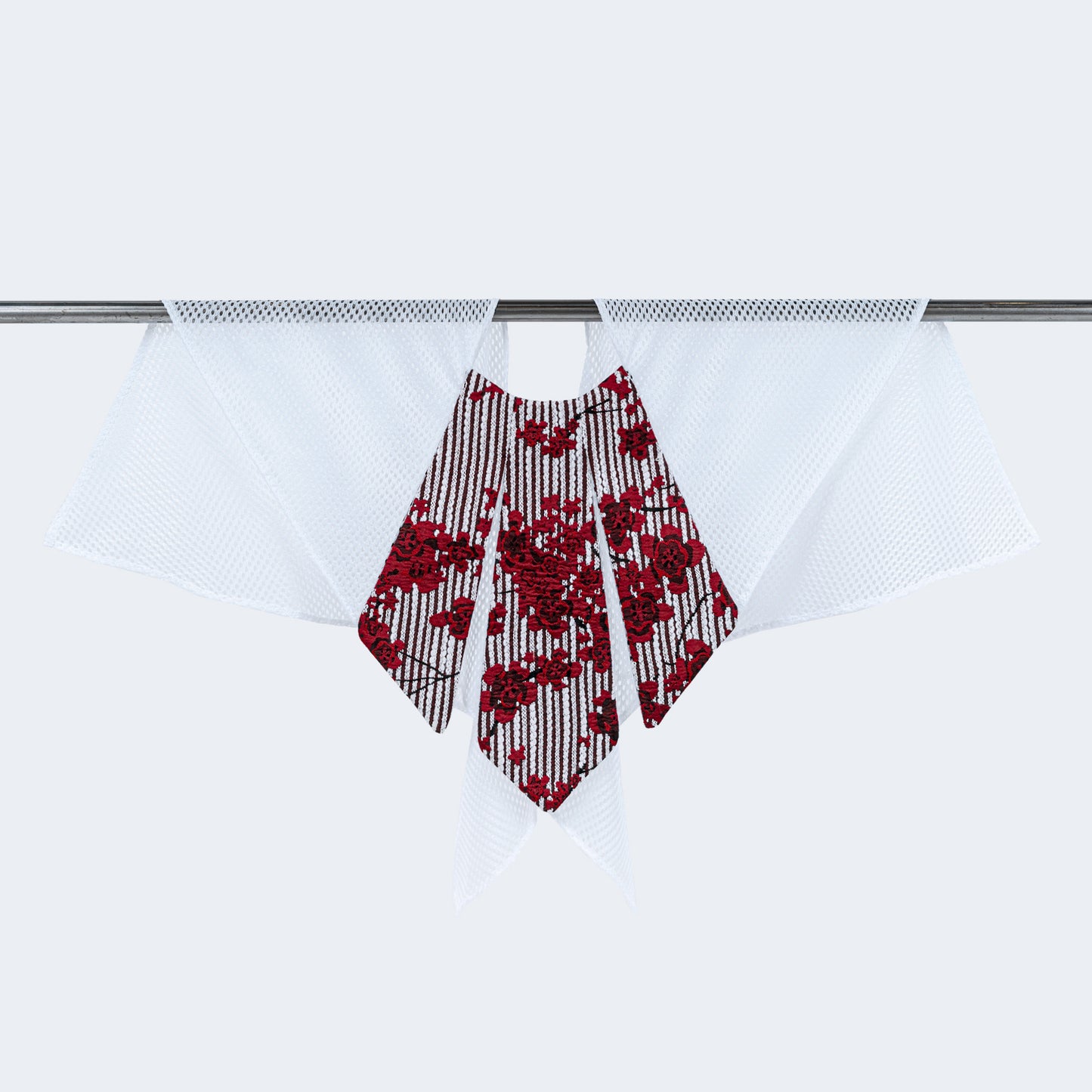 Front view of floral print collar with sheer white mesh, displayed on hanger