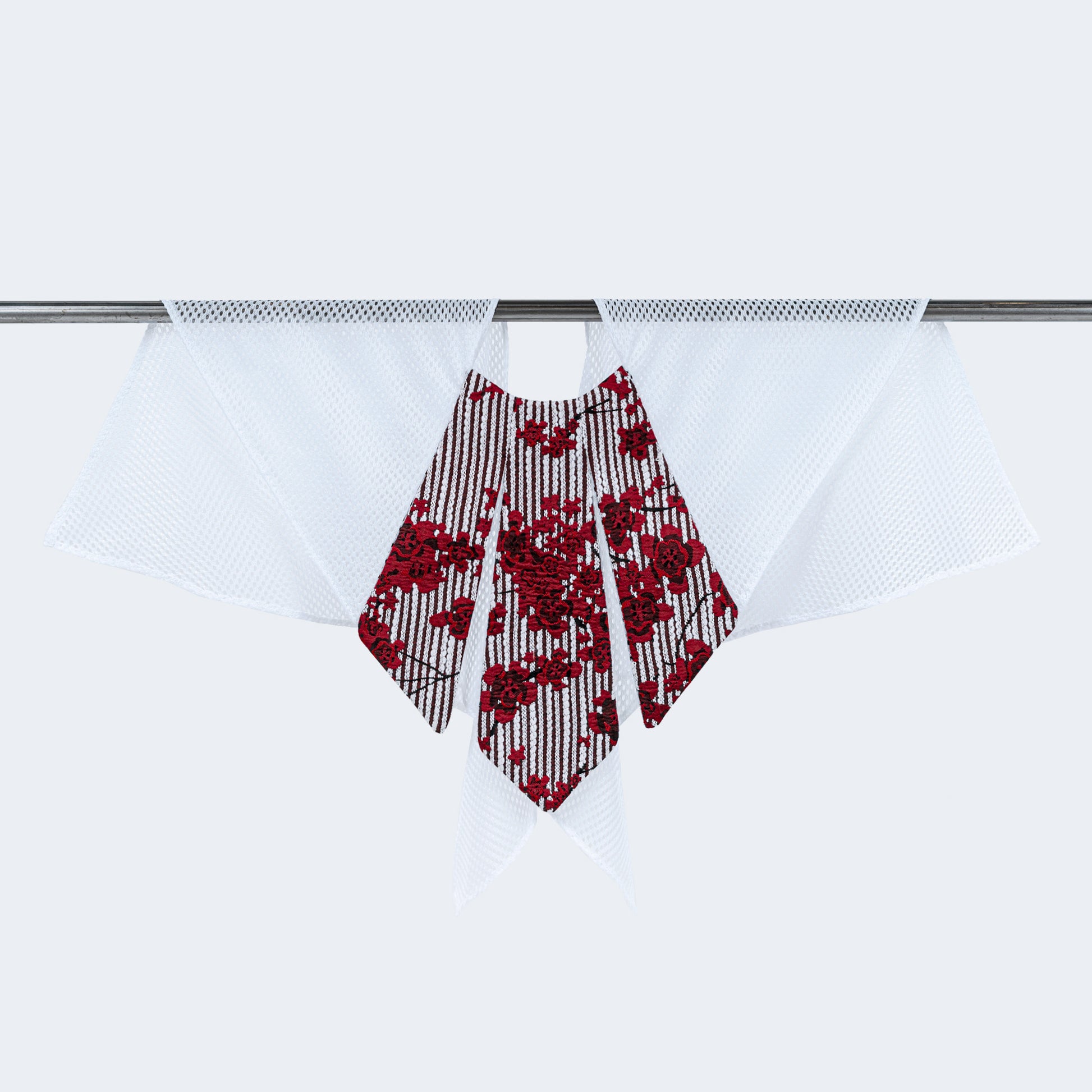 Front view of floral print collar with sheer white mesh, displayed on hanger