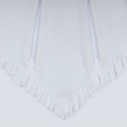 Close-up of white denim and sheer mesh fabric under natural light
