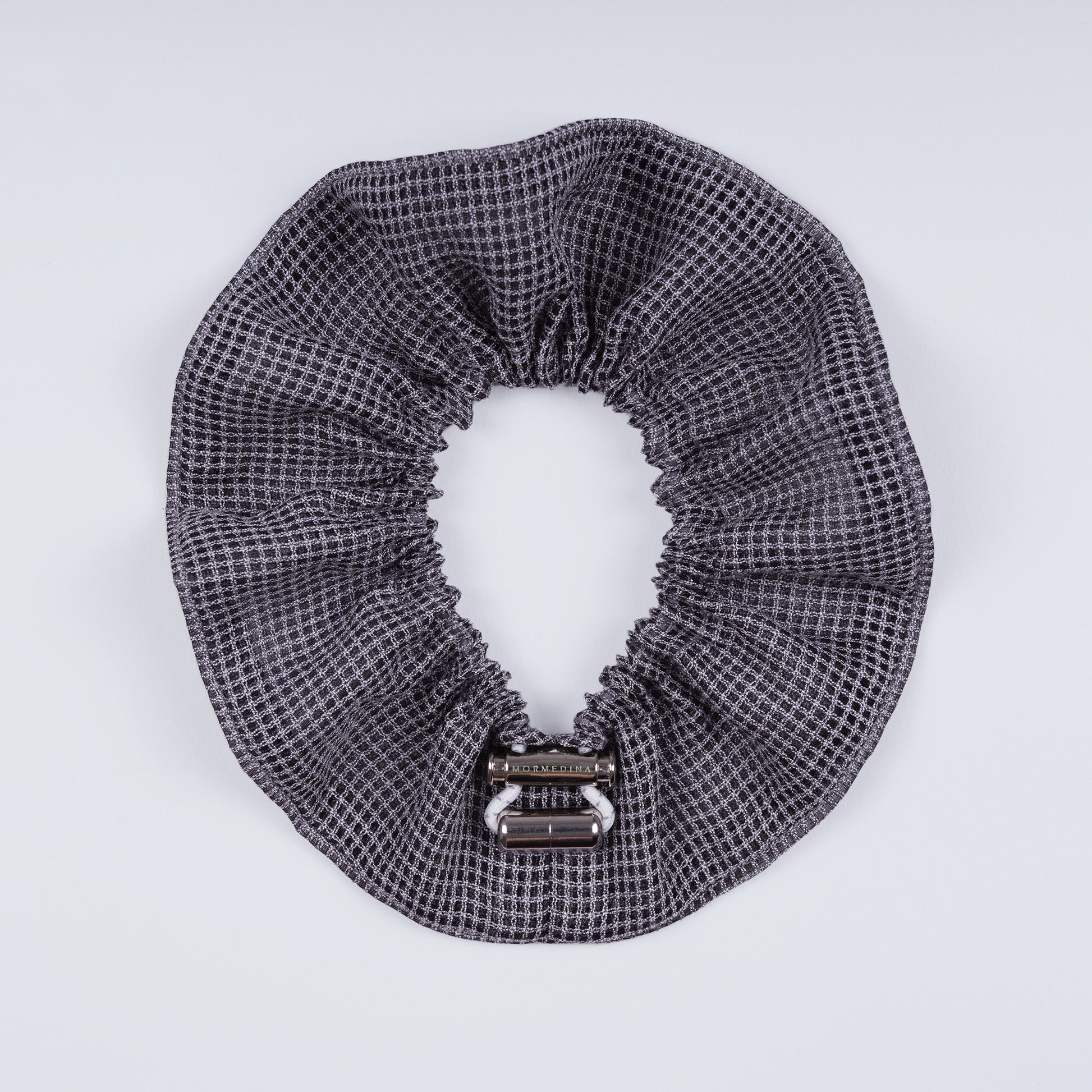 Gray squares scrunchie opened fully to show the flexible elastic and structured design.