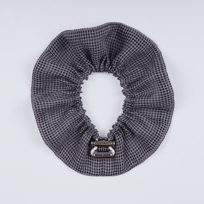 Gray squares scrunchie opened fully to show the flexible elastic and structured design.