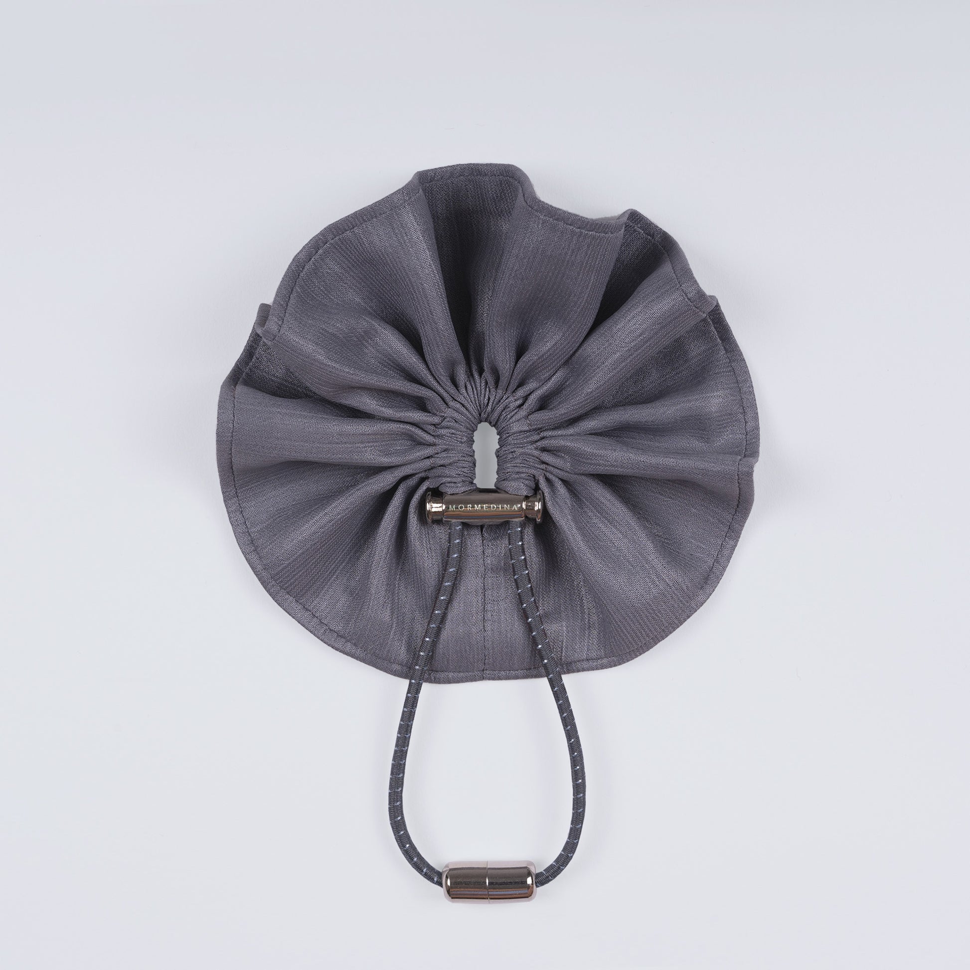 Shiny silver scrunchie displayed closed on a white background, showing its unique fastener and smooth texture.
