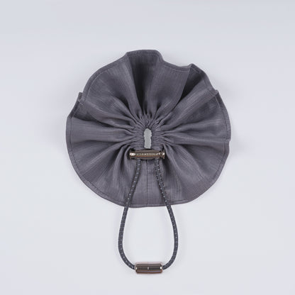 Shiny silver scrunchie displayed closed on a white background, showing its unique fastener and smooth texture.