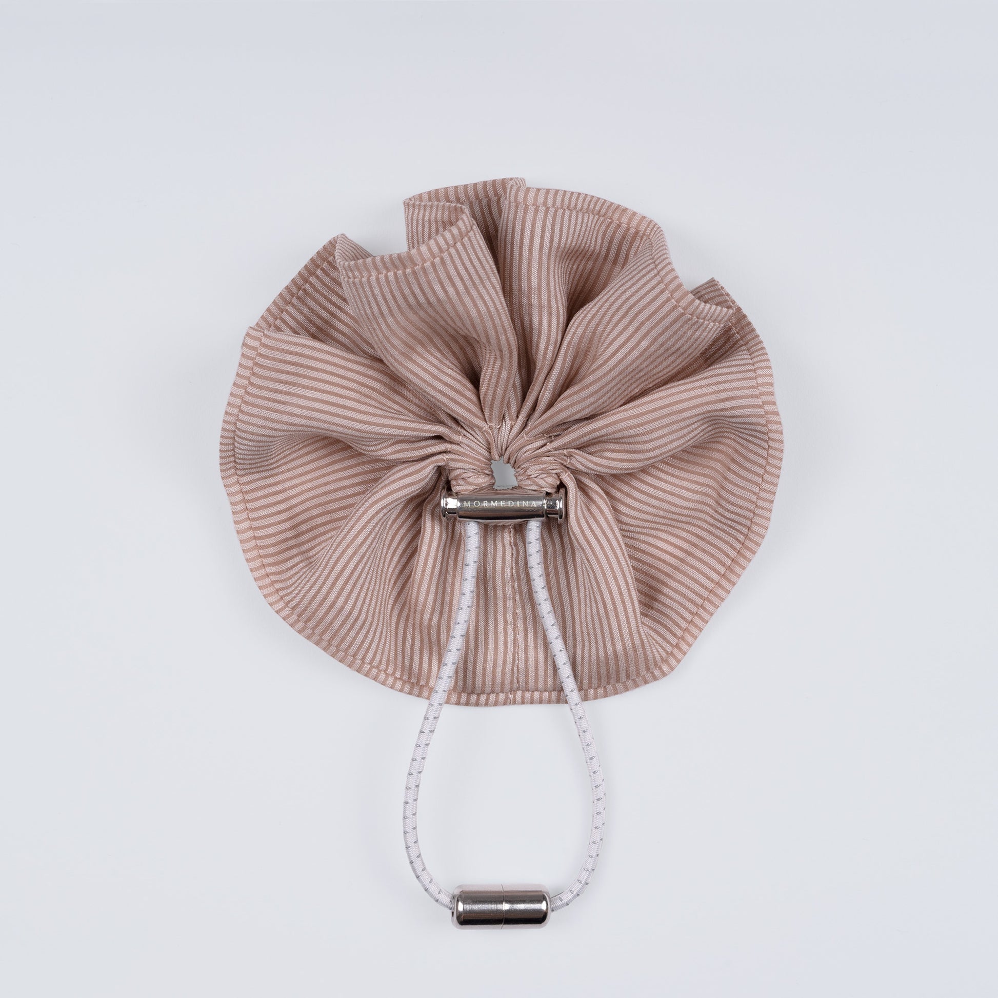Nude brown and pink striped scrunchie displayed closed on a white background, showing the unique fastener.