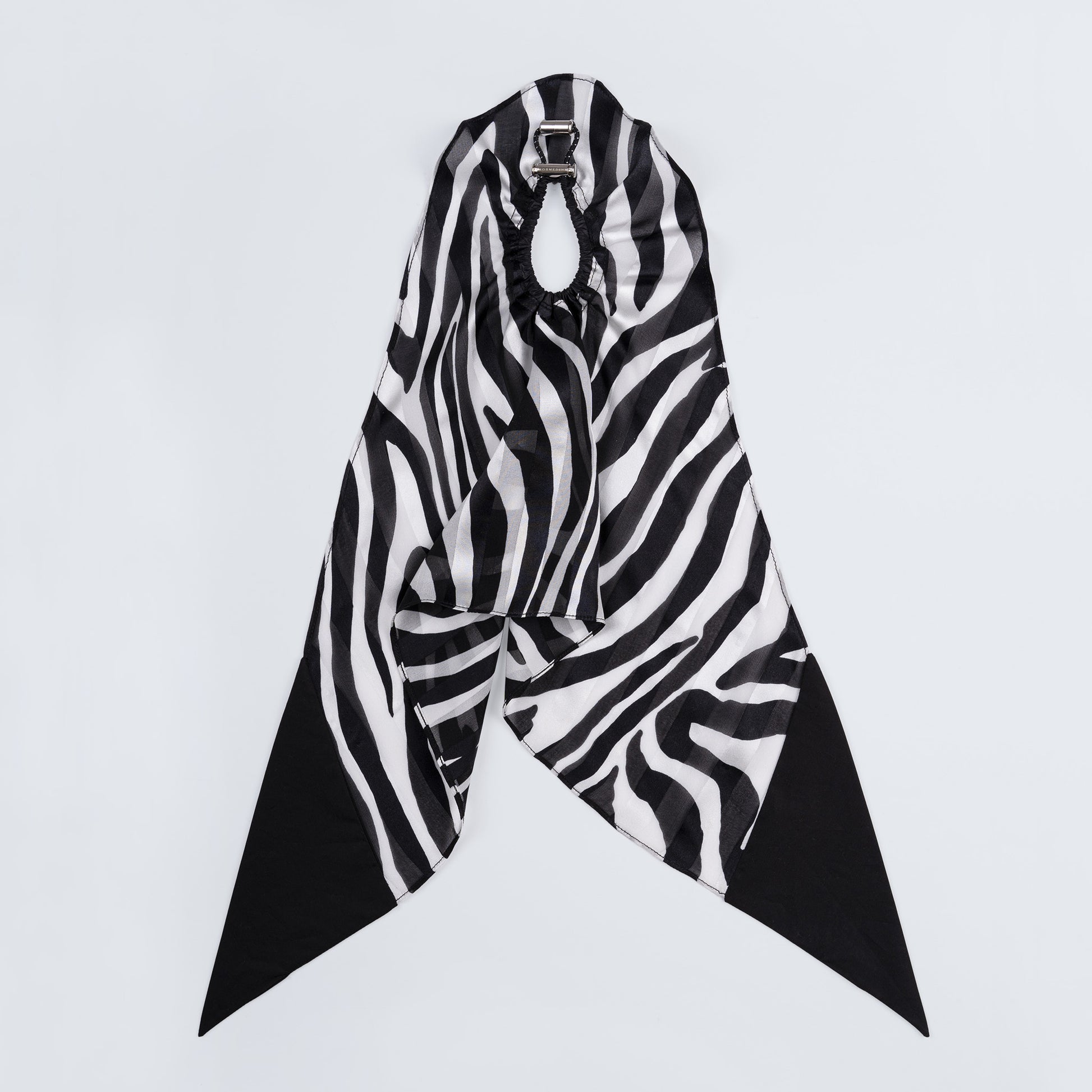 Silk scrunchie opened fully, revealing flexible elastic and distinct zebra print pattern.