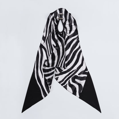 Silk scrunchie opened fully, revealing flexible elastic and distinct zebra print pattern.