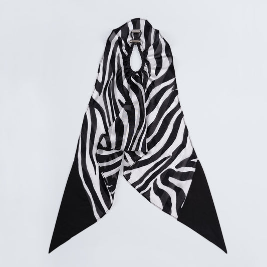 Silk scrunchie opened fully, revealing flexible elastic and distinct zebra print pattern.